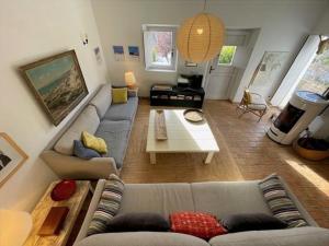 a living room with a couch and a table at Tina`s House - Bordeira in Aljezur