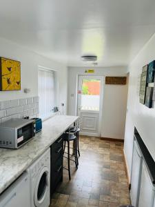 a kitchen with a counter top with a microwave at Scarisbrick Apartment Sleeps 6 in Scarisbrick