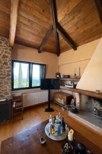 a living room with a piano and a fireplace at Olive House Galaxidi in Galaxidi