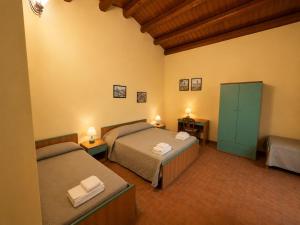 a bedroom with two beds and a green cabinet at Agriturismo L'Antica Vigna in Randazzo +66 photos