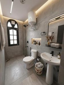 a bathroom with a white toilet and a sink at Siesta B&B Private Balcony & Himalayan Sunrise Views in Shimla