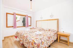 a bedroom with a large bed and a table at Apartamento Felipe 1-4 in Cala d´Or +17 photos