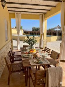 a wooden table with fruit on it on a patio at Villa rural en Marchena in Marchena