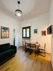 a living room with a table and a couch at Alpine Cozy Studio Limone Piemonte in Limone Piemonte