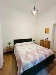 a bedroom with a bed with a quilt on it at Alpine Cozy Studio Limone Piemonte in Limone Piemonte