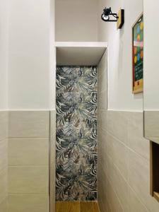 a hallway in a bathroom with a wall at Alpine Cozy Studio Limone Piemonte in Limone Piemonte