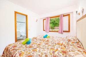 a bedroom with a bed with two pillows on it at Apartamento Felipe 2-2 in Cala d´Or +20 photos