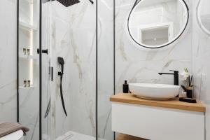 a bathroom with a sink and a shower at Aura Airport Suite in Spata