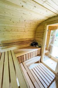 a wooden sauna with a bench in a room at Apartment Kranich by Interhome in Granzin