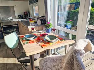 a kitchen with a table with glasses of wine at Holiday Home Tiny Haus Heidi by Interhome in Beilngries +17 photos
