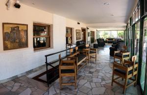 a room with a bunch of chairs and a living room at Hotel ITALIA in La Falda