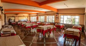 a restaurant with tables and chairs in a room at Hotel ITALIA in La Falda