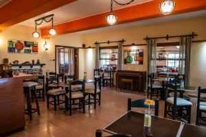 a restaurant with tables and chairs and a bar at Hotel ITALIA in La Falda
