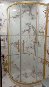 a shower with a glass door in a bathroom at Steady - Guests Rooms in Varna City