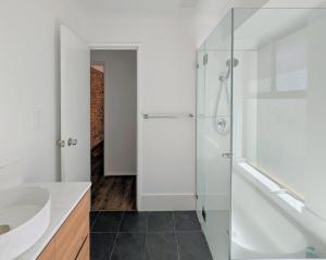 a white bathroom with a tub and a sink at 3-Bed home with large backyard in Mandurah +24 photos