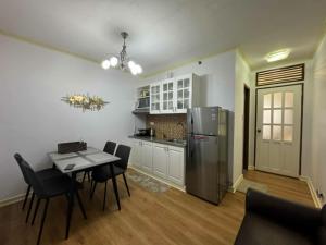 a kitchen with a table and a stainless steel refrigerator at Condotels at Albergo Hotel Baguio in Baguio +11 photos