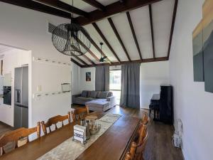 a living room with a table and a couch at 3-Bed home with large backyard in Mandurah