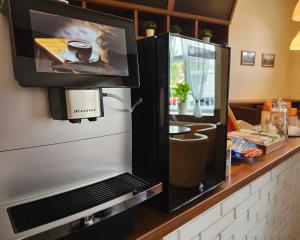 a refrigerator with a tv on a counter at Residence Vysta in Prague +37 photos