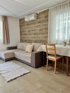 a living room with a couch and a table at Harmónia faházak in Bogács