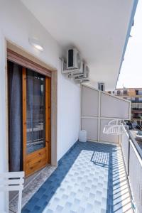 a balcony with a wooden door on a building at Prestige House 6 in Scalea