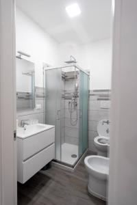 a bathroom with a shower and a sink and a toilet at Prestige House 6 in Scalea