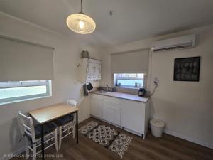 a kitchen with a table and a sink and a table and chairs at על הגג במדבר in Mitzpe Ramon +14 photos