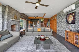 a living room with a couch and a fireplace at SaffronStays Blooming Stone in Kotagiri