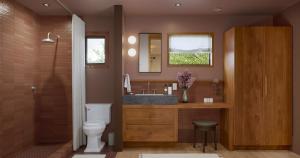 a bathroom with a toilet and a sink and a mirror at Oyster Estate in Greenport