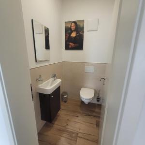 a bathroom with a sink and a toilet at Ferienwohnung Ramona in Sonneberg +11 photos