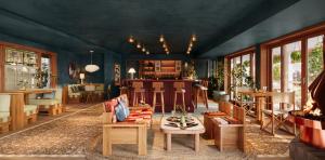 a living room with blue walls and wooden furniture at Oyster Estate in Greenport
