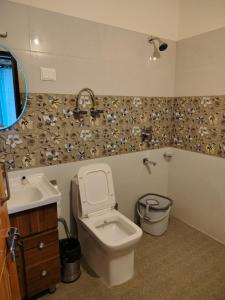 a bathroom with a toilet and a sink at The sky walk in Manāli +24 photos