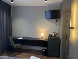 a room with a desk and a chair in a room at Zatyshok Затишок in Rokytne