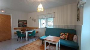 a living room with a blue couch and a table at Wellness apartmán TERASA in Bozkovska