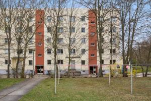 a large building with a fence in front of it at Am Ring Monteurzimmer Apartment Böhlen in Böhlen