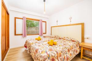 a bedroom with a bed with yellow pillows on it at Apartamento Felipe 1-3 in Cacla D'or +19 photos