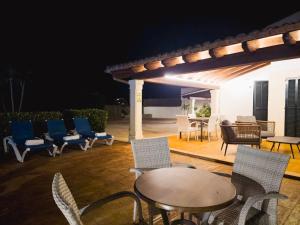 a table and chairs on a patio at night at Finca Boy in Pollença