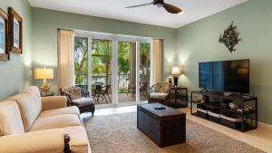 a living room with a flat screen tv and a couch at 203 Mariners Club in Key Largo