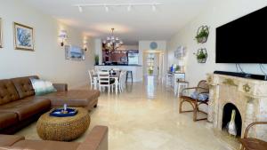 a living room with a couch and a fireplace at 333 Mariners Club in Key Largo