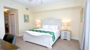 a white bedroom with a white bed and a desk at 333 Mariners Club in Key Largo +44 photos
