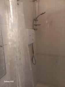 a bathroom with a shower with a shower curtain at Fishing in Foxford
