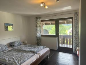a bedroom with a bed and a large window at Ferienhaus Samy - Feldberg in Feldberg