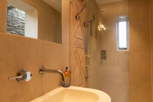 a bathroom with a sink and a shower with a mirror at The Nook in South Cerney +21 photos