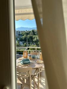 a table and chairs on a balcony with a view at Casa Eira's Dhermi in Gjilek