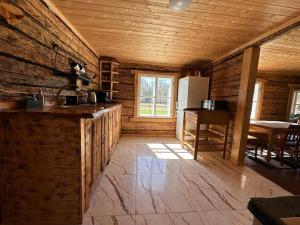 a kitchen with a refrigerator and a table in a room at Metsatoa in Alliklepa