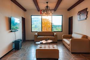 a living room with two couches and a table at Finca La Macarena, Playas Villamil in Playas
