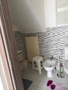 a bathroom with a toilet and a sink at Appartamento Camponovo in Chiasso +12 photos