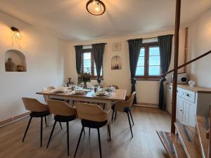 a dining room with a wooden table and chairs at Búda u Totevú in Skalica
