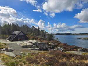 a cabin on the shore of a body of water at Cabin in Leirvåg in Leirvåg