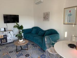 a living room with a blue couch and a table at Muring Apartments in Tribunj