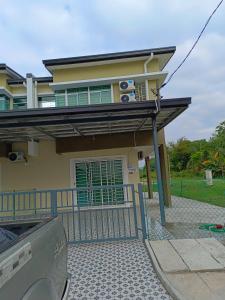 a house with a balcony and a car parked in front at TBSC by Reemon in Keningau +9 photos